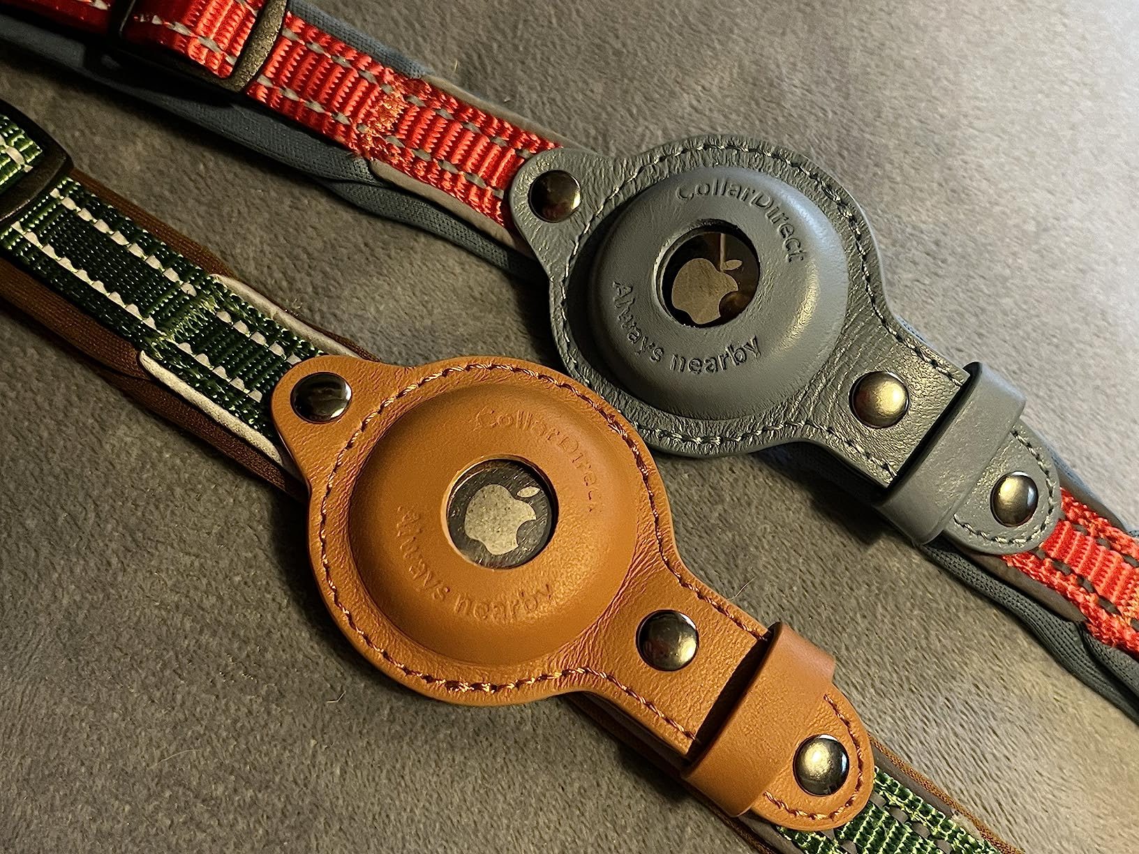 Two AirTag holders attached to dog collars (tan and grey leather), representing a candidate for the best AirTag dog collar